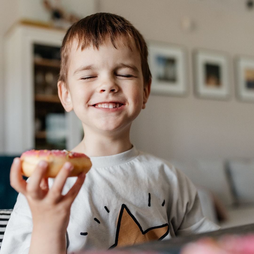 A boy holding a doughnut